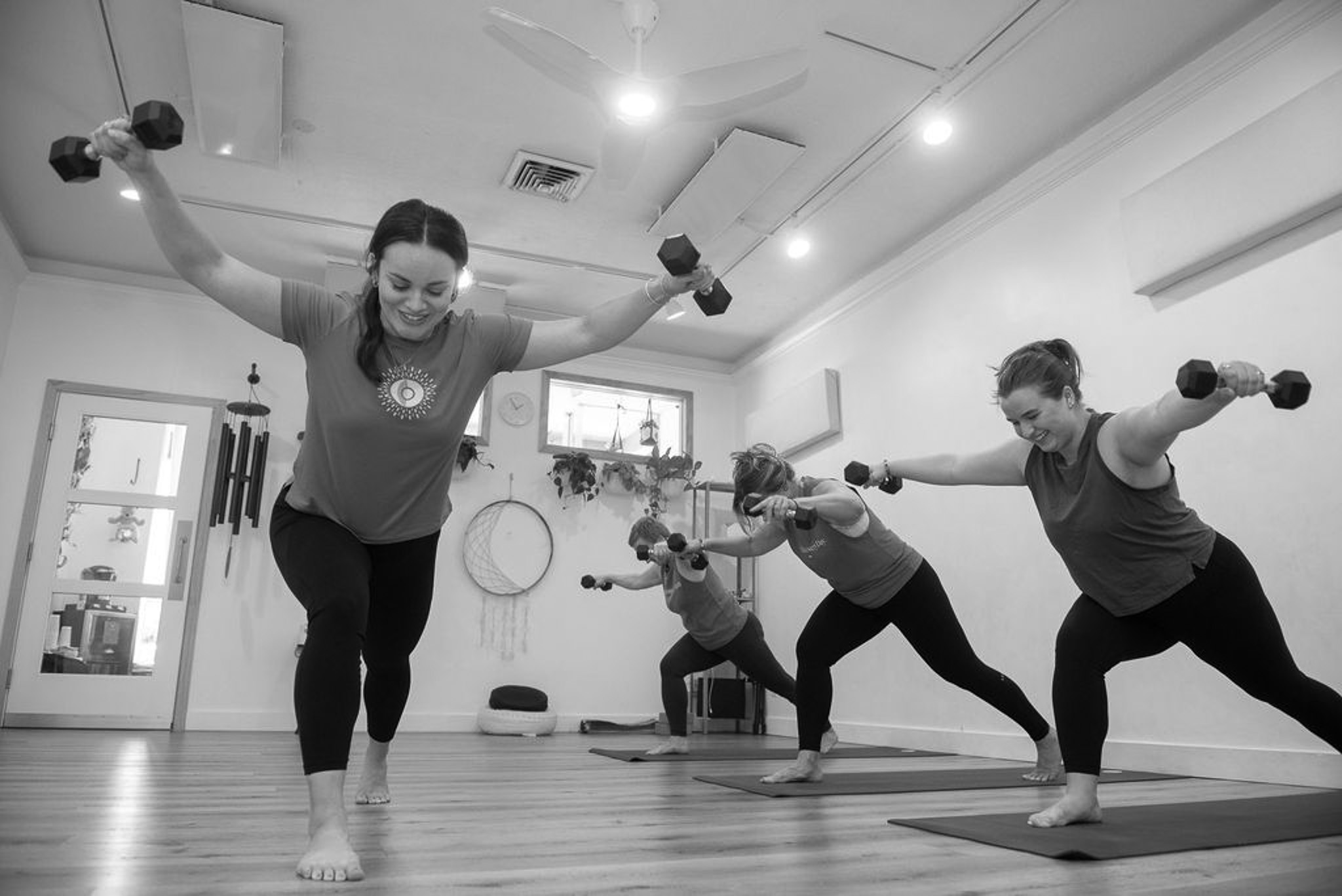 Jacquelyn using dumbbells in Yoga Strength, a yoga based strength and conditioning class, at The Energy Lab in Redlands, CA.