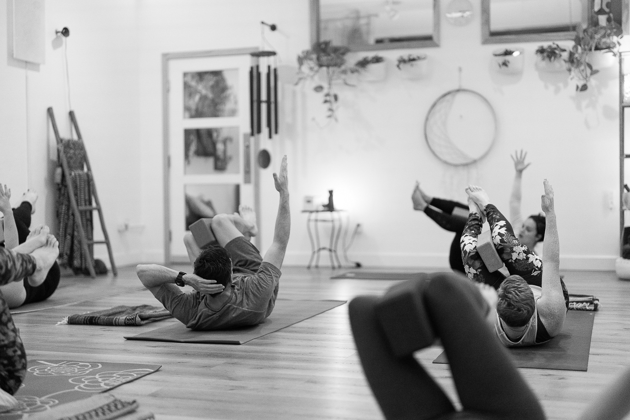 People on yoga mats doing yoga in a vinyasa class at The Energy Lab in Redlands, CA