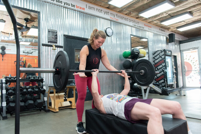 Jill helping spot a client during a personal training session at The Energy Lab in Redlands, CA.
