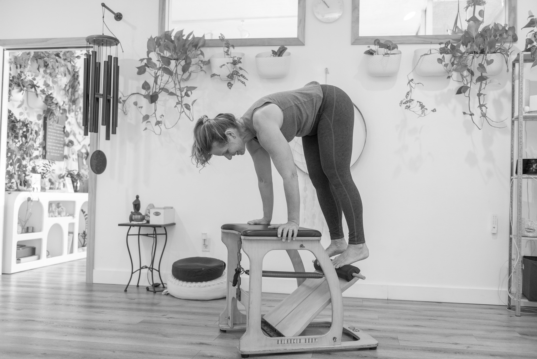 Jill using a pilates chair during a mat pilates class in the yoga space at The Energy Lab in Redlands, CA.