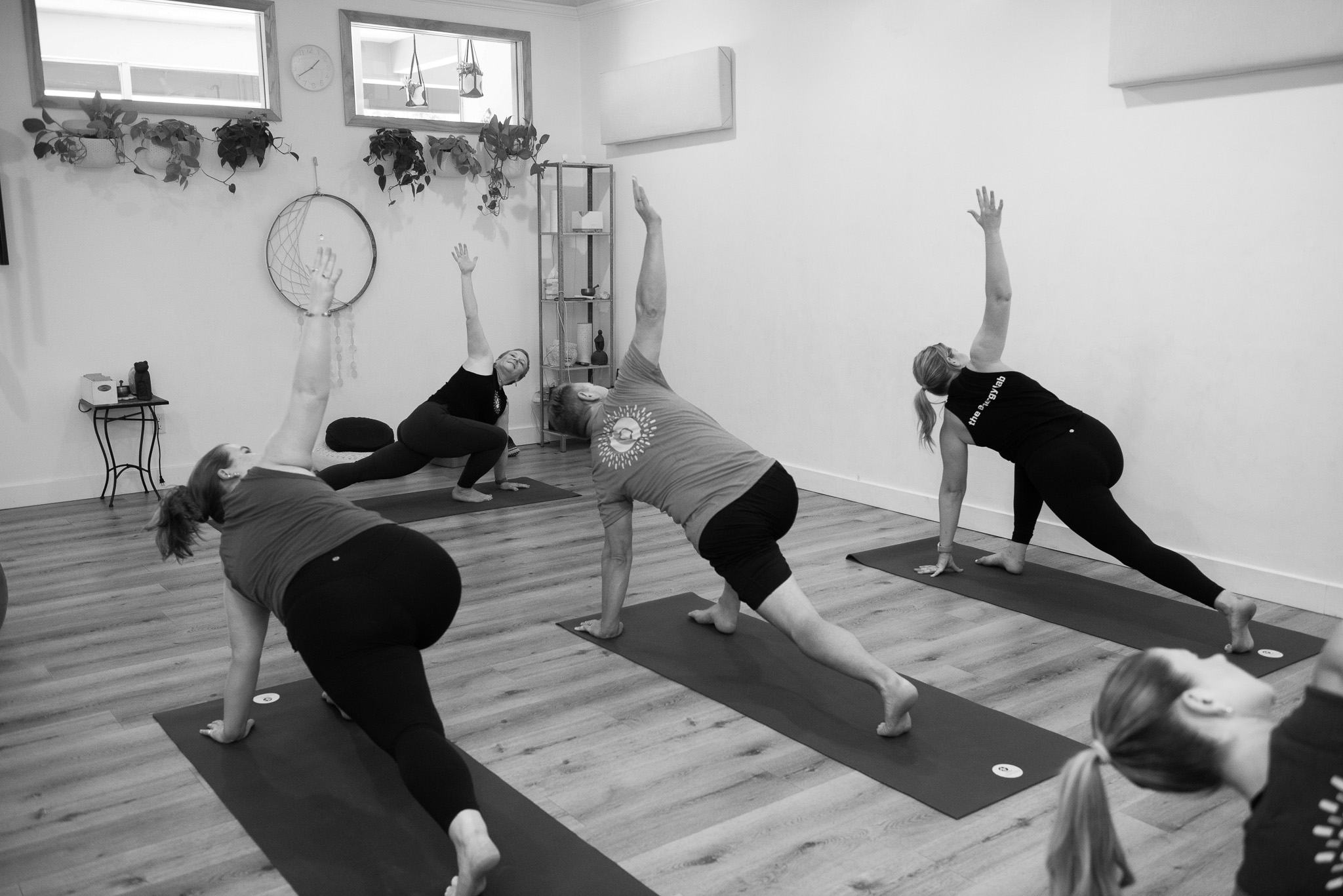 Molly leading students through a crescent pose in an All Levels Vinyasa Yoga Flow class at The Energy Lab in Redlands, CA