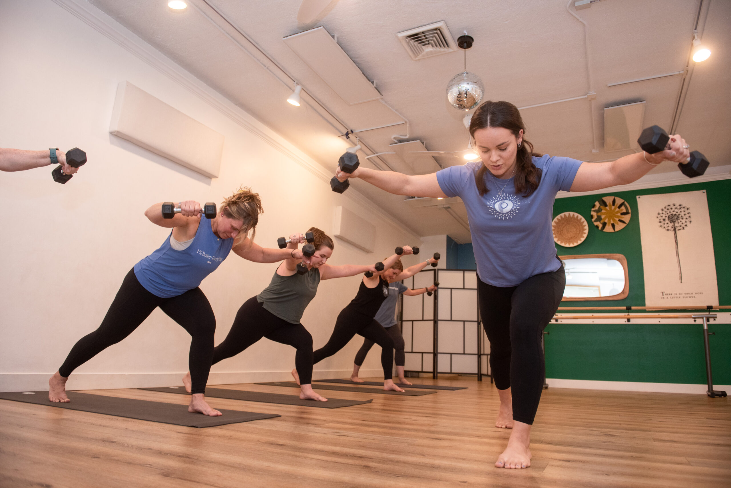 Jacquelyn teaching students with dumbbells during a sculpt class at The Energy Lab in Redlands, CA.