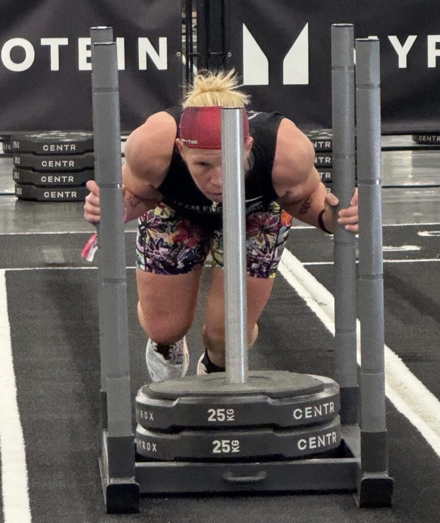 Cindy pushing a sled during Hyrox Las Vegas competition, from The Energy Lab.