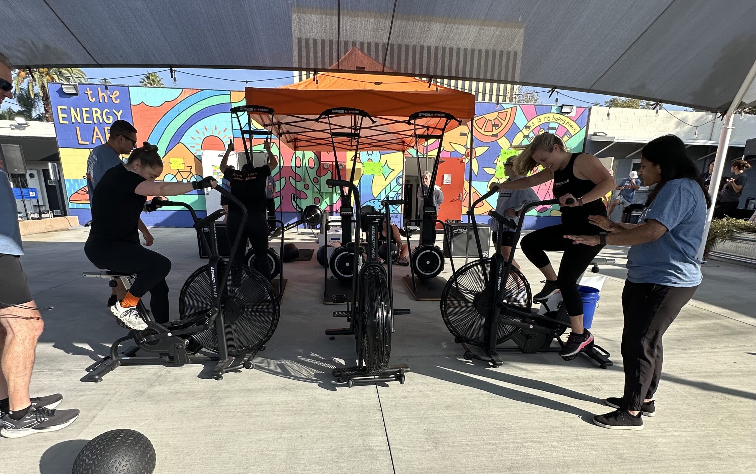Jasmeen and Coco competing on an assault bike during a DEKA Competition at The Energy Lab in Redlands, CA.