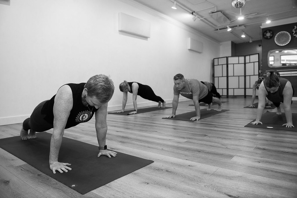 Molly leading students in a plank during Level 1 Gentle Flow yoga class at The Energy Lab in Redlands, CA