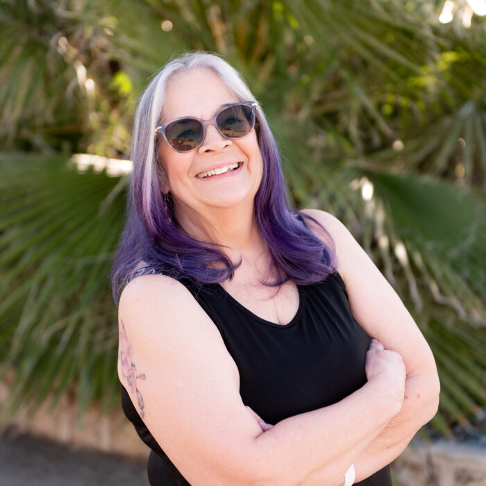 Personal trainer Germaine standing in front of a tree at The Energy Lab in Redlands, CA