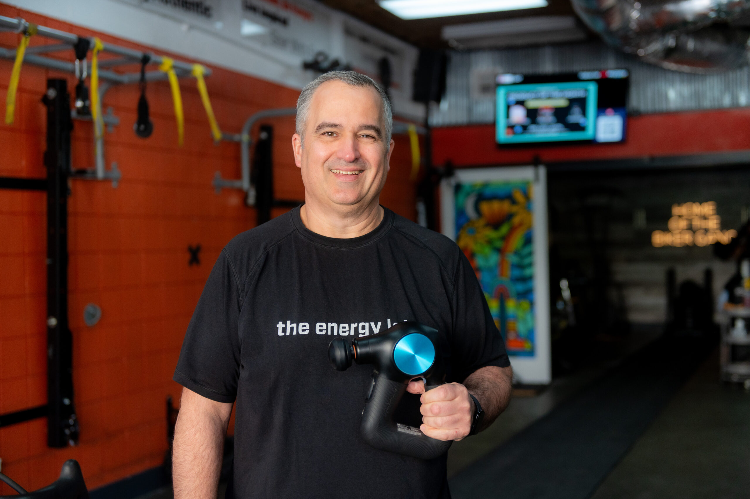 Sean holding a Theragun at The Energy Lab in Redlands, CA.