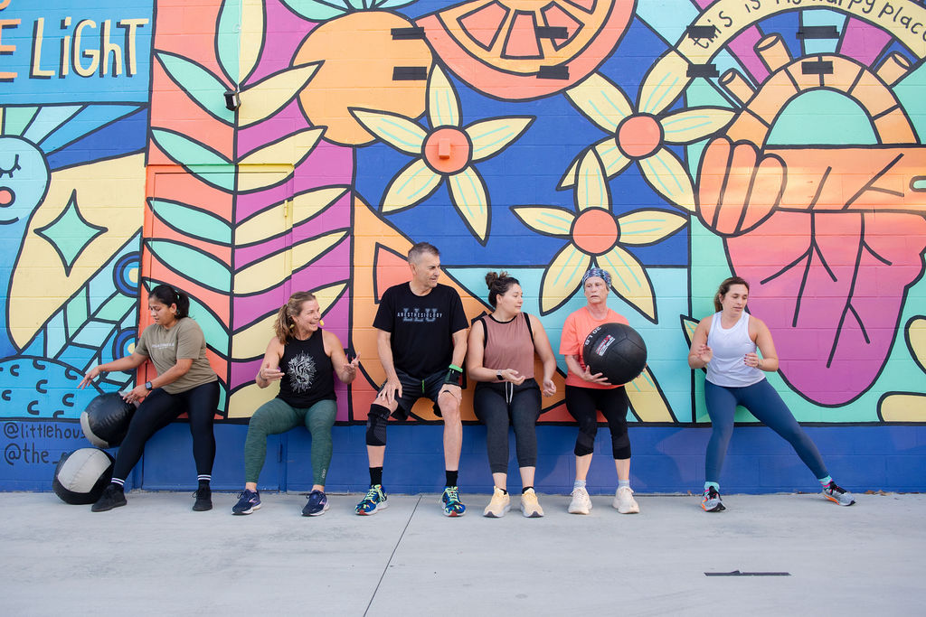 Clients doing sitting wall ball during a Breakthrough group fitness class at The Energy Lab in Redlands, CA.
