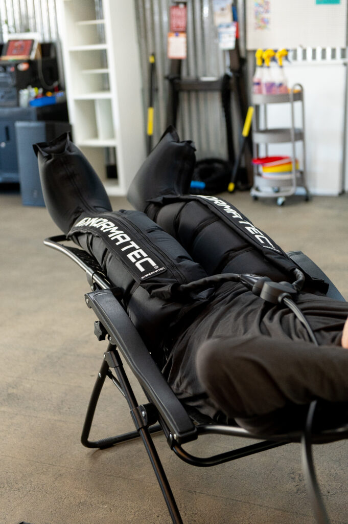 Client using Normatec compression pants at The Energy Lab in Redlands, CA.