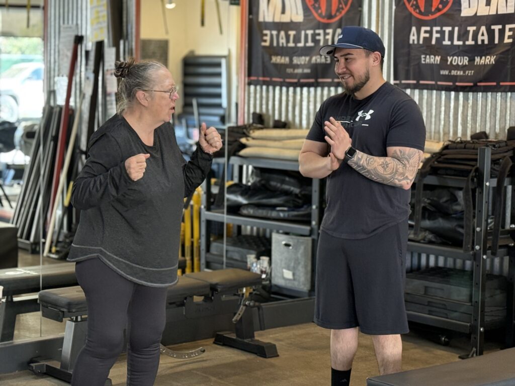 Isaac explains an exercise to a client during a personal training session at The Energy Lab in Redlands, CA.