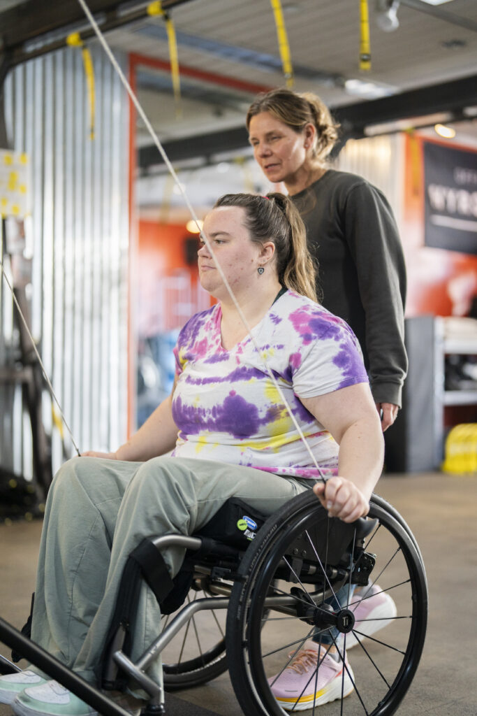 Jill coaching Ella on a SkiERG during a personal training session at The Energy Lab in Redlands, CA.