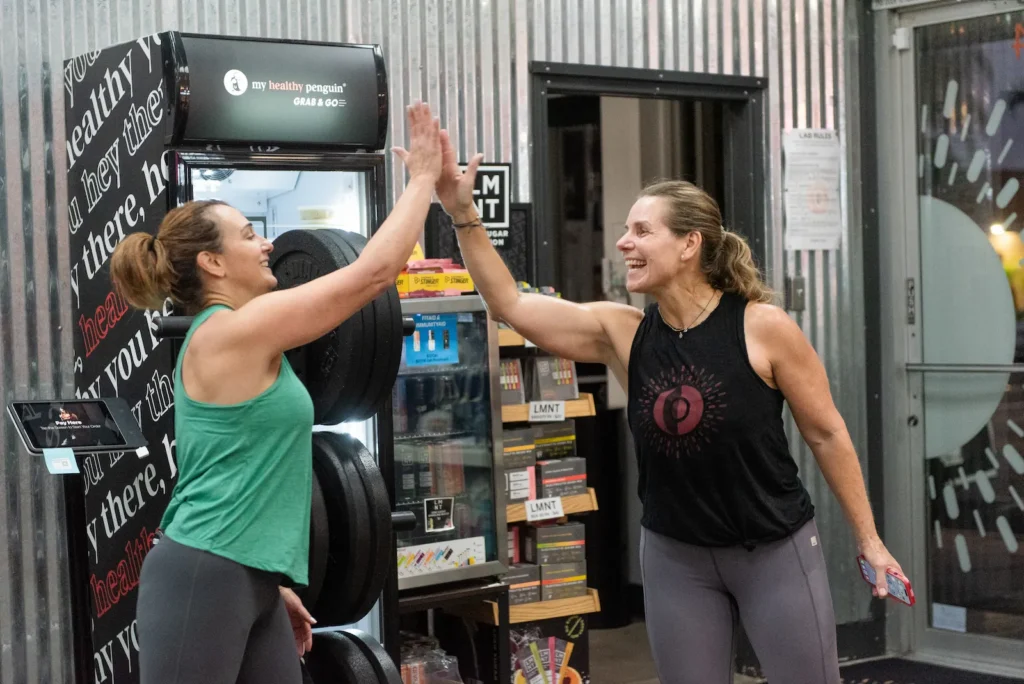 High-fives during a group fitness class at The Energy Lab