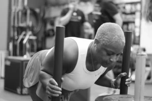 A client pushing a sled during Hybrid Training class at The Energy Lab in Redlands, CA