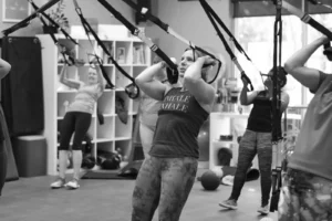 Jill doing a TRX curl during a TRX class at The Energy Lab in Redlands, CA