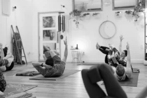 People on yoga mats doing yoga in a vinyasa class at The Energy Lab in Redlands, CA